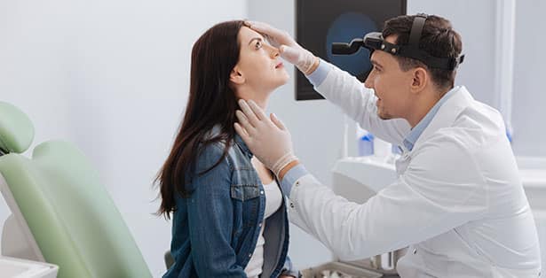 ENT doctor checking a patcients nose