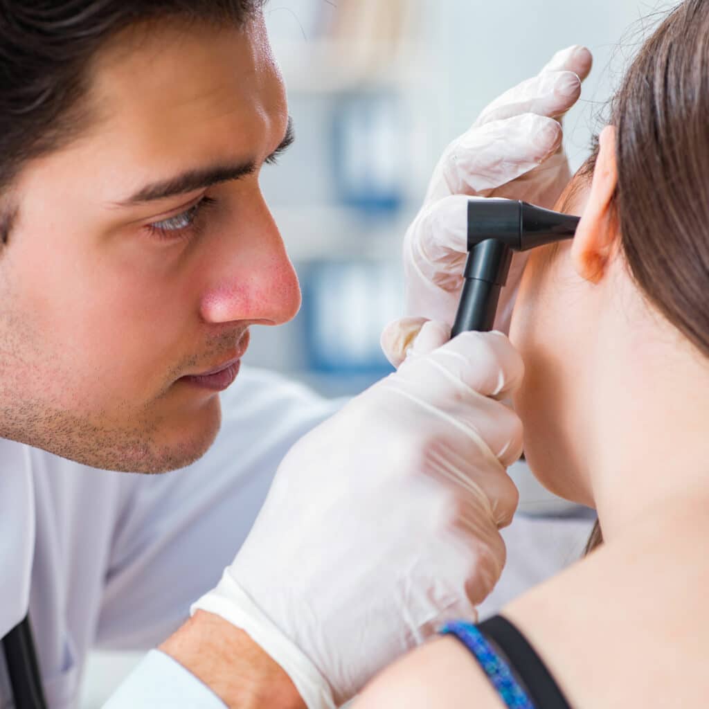 Doctor looking at a patcient's ear