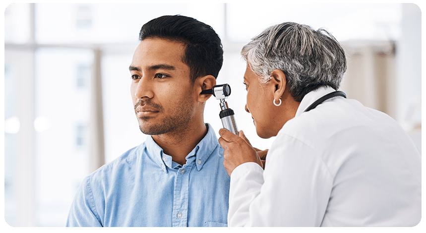 Audiologist examining a patcient's ear