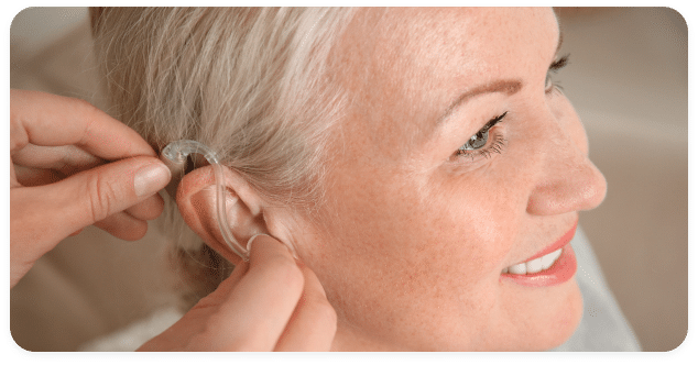 Woman getting hearing aids fitted by her hearing specialist