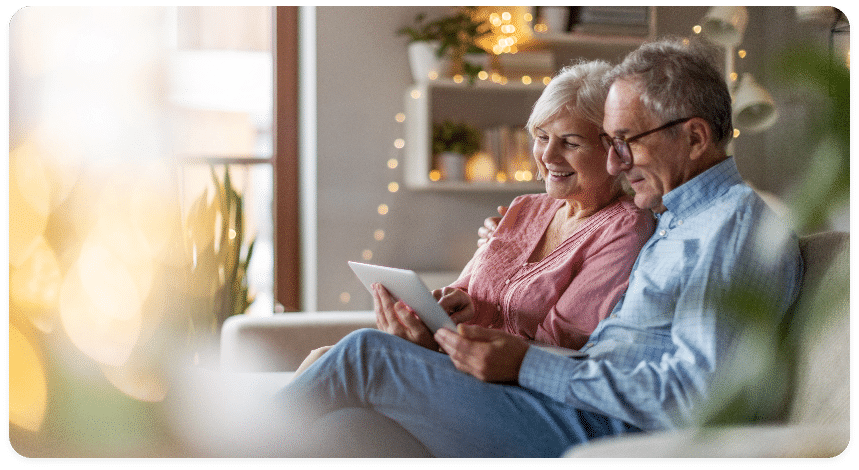 Mature couple reading about hearing services provided in their area